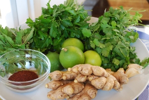 Picture of limes, ginger, spices, herbs, and garlic on a plate
